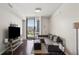 Inviting living room with floor-to-ceiling windows and comfortable seating, great views of the city at 3040 Peachtree Nw Rd # 713, Atlanta, GA 30305