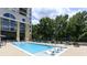 Relaxing pool area with lounge chairs, umbrellas and lush greenery in a resort-style setting at 3040 Peachtree Nw Rd # 713, Atlanta, GA 30305