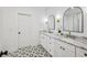 Bathroom features double vanities with marble counters and patterned floors at 1347 Midlawn Dr, Decatur, GA 30032
