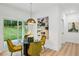 Cozy dining area with a modern light fixture, glass table, and view of the backyard through sliding doors at 1347 Midlawn Dr, Decatur, GA 30032