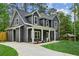 Beautiful two-story home with gray siding, white trim, and a spacious driveway in a wooded setting at 1347 Midlawn Dr, Decatur, GA 30032