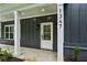 Close-up of the home's entrance with a white front door, brick base, and contemporary house number at 1347 Midlawn Dr, Decatur, GA 30032