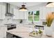 Well-lit kitchen featuring marble countertops, white cabinets, and stainless steel appliances at 1347 Midlawn Dr, Decatur, GA 30032