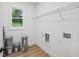 A functional laundry room with a window and wire shelving at 1347 Midlawn Dr, Decatur, GA 30032