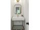 Stylish powder room with unique mirror, modern faucet, and compact sink at 1347 Midlawn Dr, Decatur, GA 30032