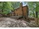 View of a brick home with a large wooden deck overlooking a landscaped backyard, offering privacy and outdoor space at 1430 Dallas Circle Sw, Marietta, GA 30064