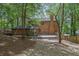 Large brick home, partially obscured by trees, featuring a multi-tiered deck and fenced yard at 1430 Dallas Circle Sw, Marietta, GA 30064