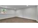 Clean unfinished basement with modern flooring, fresh paint, and a window for natural light at 1430 Dallas Circle Sw, Marietta, GA 30064