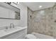Bathroom featuring vanity with quartz countertop and a stylish tiled shower at 1430 Dallas Circle Sw, Marietta, GA 30064