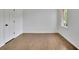 An empty bedroom featuring hardwood floors, a window, a white door, and white walls at 1430 Dallas Circle Sw, Marietta, GA 30064
