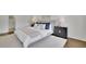Bright bedroom featuring hardwood floors, a white rug, a bed with blue and white pillows, and a black nightstand at 1430 Dallas Circle Sw, Marietta, GA 30064