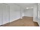 Open bedroom featuring hardwood floors, a window, white walls, and a closet at 1430 Dallas Circle Sw, Marietta, GA 30064