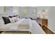 Bright bedroom featuring hardwood floors, two windows, white walls, and a wooden dresser with decor at 1430 Dallas Circle Sw, Marietta, GA 30064