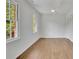 A simple bedroom featuring hardwood floors, two windows, white walls, and a closet at 1430 Dallas Circle Sw, Marietta, GA 30064