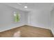 A simple bedroom featuring hardwood floors, a window, white walls, and a closet at 1430 Dallas Circle Sw, Marietta, GA 30064