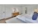 Bright bedroom featuring hardwood floors, a white rug, a bed with blue and white pillows, and a gold mirror at 1430 Dallas Circle Sw, Marietta, GA 30064