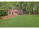 Traditional brick home with a manicured lawn, surrounded by lush greenery at 1430 Dallas Circle Sw, Marietta, GA 30064