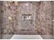 New shower with bronze and gray large square tiling and gold shower fixtures at 1430 Dallas Circle Sw, Marietta, GA 30064