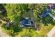 Aerial view of the home with a dark roof, surrounding trees, and long driveway at 2111 Holly Hill Dr, Decatur, GA 30032
