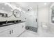 Elegant bathroom featuring a glass-enclosed shower, marble tile, a double sink vanity, and modern fixtures at 2111 Holly Hill Dr, Decatur, GA 30032
