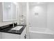 Modern bathroom featuring a sleek vanity with black countertop and a tub-shower combo with white subway tile at 2111 Holly Hill Dr, Decatur, GA 30032