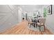 Open dining area with hardwood floors, modern decor, a round table with four chairs, and access to the kitchen at 2111 Holly Hill Dr, Decatur, GA 30032