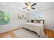 Serene main bedroom featuring hardwood floors, tray ceilings, two large windows, and a comfortable queen-sized bed at 2111 Holly Hill Dr, Decatur, GA 30032