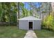 Concrete storage shed in a wooded backyard with a partial view of the open doorway at 2111 Holly Hill Dr, Decatur, GA 30032