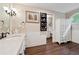 Bathroom features a vanity with storage, a round window, and wood look floors at 5027 Castlewood Sw Dr, Lilburn, GA 30047