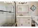 Bright bathroom with a glass-enclosed shower, vanity with granite countertops, and modern fixtures at 5027 Castlewood Sw Dr, Lilburn, GA 30047