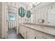Bathroom with granite countertops, decorative mirror and patterned wallpaper at 5027 Castlewood Sw Dr, Lilburn, GA 30047