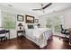 Bedroom with hardwood floors, a ceiling fan, and a large window at 5027 Castlewood Sw Dr, Lilburn, GA 30047