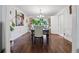 Formal dining room with hardwood floors, elegant table setting, wainscoting, and stylish décor at 5027 Castlewood Sw Dr, Lilburn, GA 30047