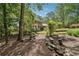 Brick home with green shutters, landscaped yard, and a stone path at 5027 Castlewood Sw Dr, Lilburn, GA 30047