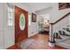 Inviting foyer featuring hardwood floors, elegant staircase, and decorative front door with stained glass at 5027 Castlewood Sw Dr, Lilburn, GA 30047