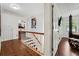 Upstairs hallway leading to bedrooms, featuring wood floors and a staircase at 5027 Castlewood Sw Dr, Lilburn, GA 30047