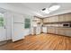Functional kitchen with wooden cabinets, appliances, and hardwood floors at 5027 Castlewood Sw Dr, Lilburn, GA 30047
