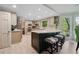 Bright kitchen featuring a large island, modern countertops, ample storage, and a breakfast bar with stools at 5027 Castlewood Sw Dr, Lilburn, GA 30047