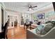 Inviting living room with sports memorabilia, wood floors and large windows at 5027 Castlewood Sw Dr, Lilburn, GA 30047