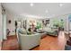 Spacious living room featuring hardwood floors, comfortable seating and lots of natural light at 5027 Castlewood Sw Dr, Lilburn, GA 30047