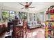 Bright sun room with bar, comfortable seating, and large windows at 5027 Castlewood Sw Dr, Lilburn, GA 30047