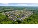 An aerial view showcases a neighborhood filled with beautiful homes and lush green spaces at 10140 Grandview Sq, Duluth, GA 30097