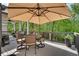 Charming back deck features a dining table with umbrella and overlooks a wooded backyard at 10140 Grandview Sq, Duluth, GA 30097