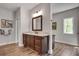 Bright bathroom with double vanities, wood-look flooring, and well-lit mirrors at 10140 Grandview Sq, Duluth, GA 30097