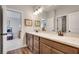 Bathroom features double sink vanity with wood cabinetry and granite counters at 10140 Grandview Sq, Duluth, GA 30097
