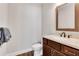 Half bathroom features a single sink vanity and wood look flooring at 10140 Grandview Sq, Duluth, GA 30097