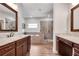 Elegant bathroom featuring double vanities, a soaking tub, and a walk-in shower with stone tile at 10140 Grandview Sq, Duluth, GA 30097