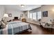 Bright bedroom features two twin beds, a window seat, and hardwood floors at 10140 Grandview Sq, Duluth, GA 30097