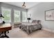 Bright bedroom features natural light, a desk, and a stylish upholstered bench at 10140 Grandview Sq, Duluth, GA 30097