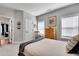 Cozy bedroom featuring neutral tones, warm wood accents, and natural light streaming through the windows at 10140 Grandview Sq, Duluth, GA 30097